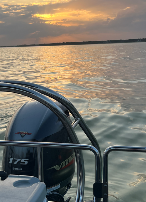Close-up of a Yamaha 175 VMAX SHO outboard motor on a Roam NTX rental boat at sunset in Little Elm, TX.