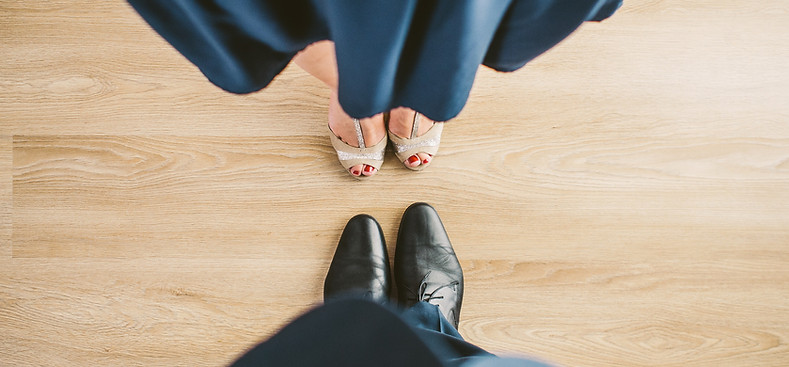 Couple’s feet facing each other, about to dance—symbolizing the relational cycle, connection, and the delicate balance.