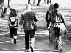 Students walking across a university campus