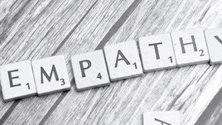 Scrabble pieces on a table spelling out the word Empathy