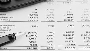 An annual account statement with a ballpoint pen and calculator