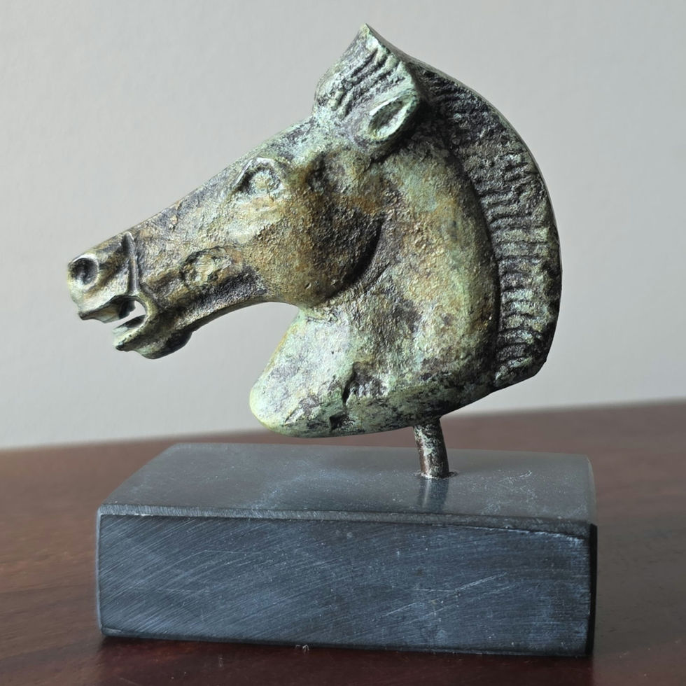 Bronze horsehead sculpture on a marble base