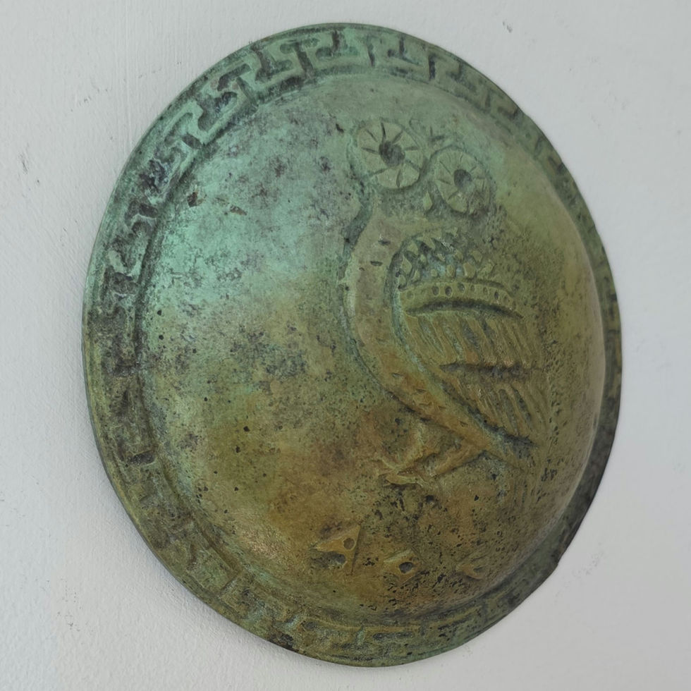 small bronze wall-mounted shield with the owl of Athens