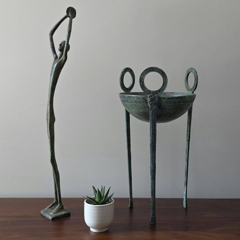 slim stylised bronze discusthrower