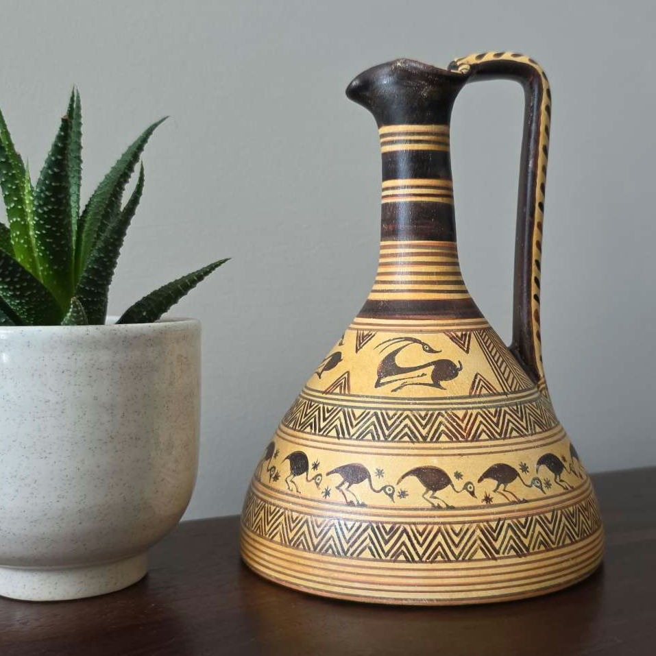 Geometric oinochoe with ibex and birds on a desk