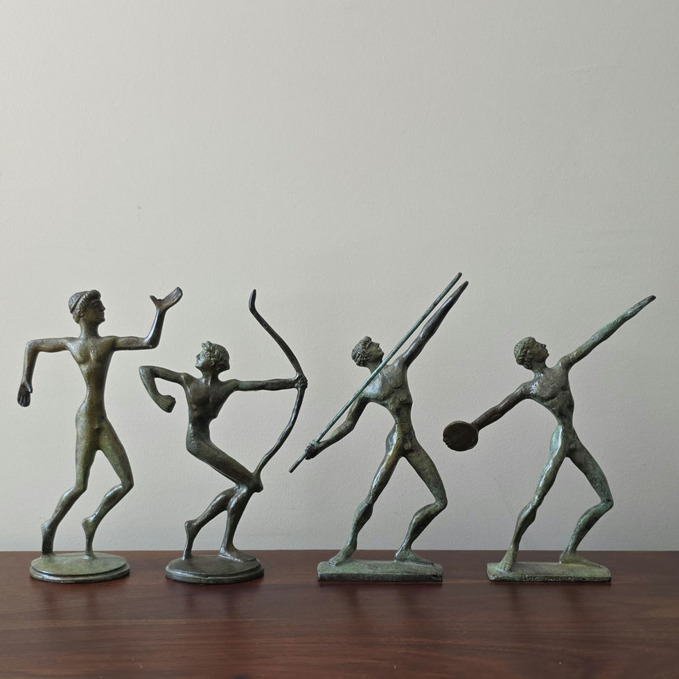 stylised slim bronze figurine of a runner in motion