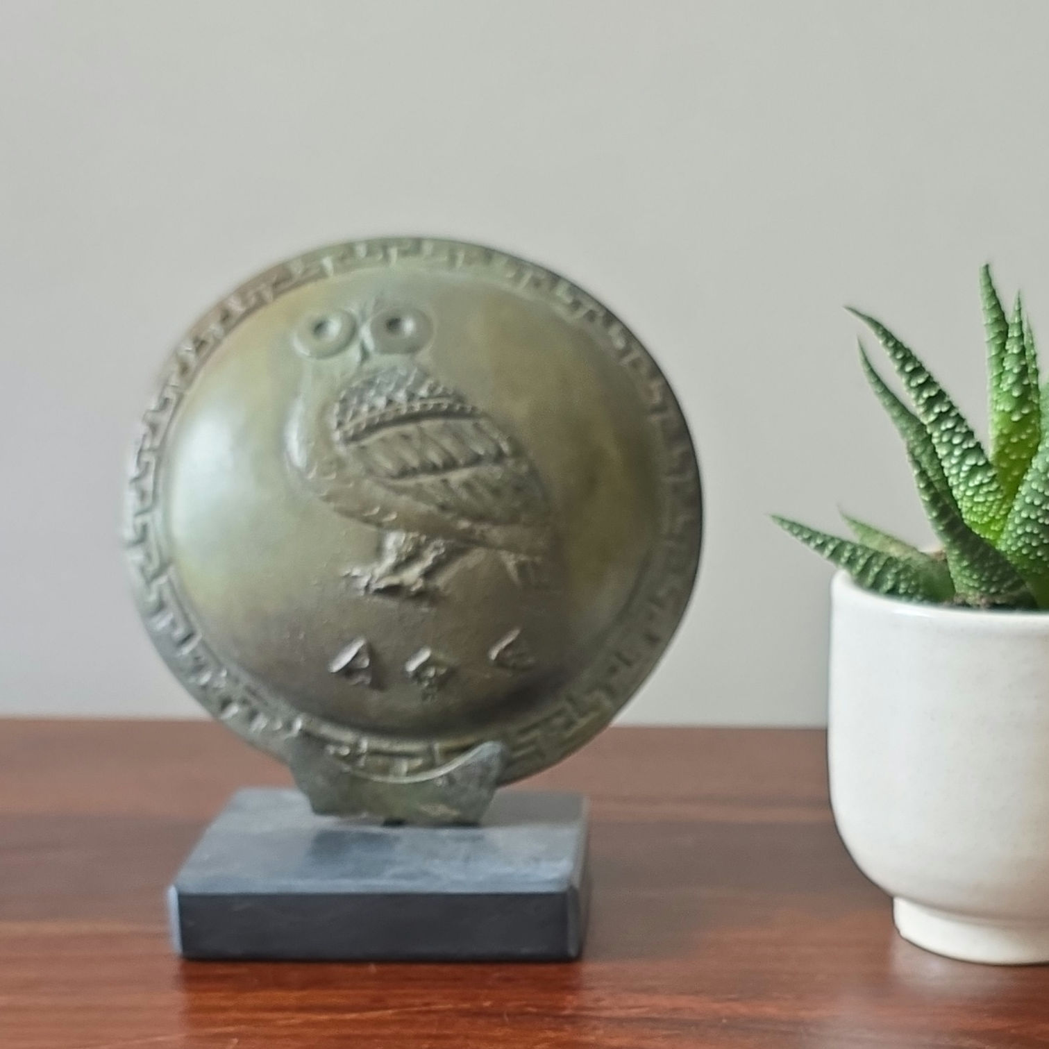 small bronze shield with the owl of Athens