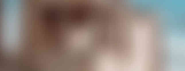 The Erechtheion, an ancient Greek temple on the Acropolis of Athens, showcasing the famous Porch of the Caryatids. The six graceful female statues, known as Caryatids, serve as architectural columns supporting the porch. Their intricate drapery and lifelike poses reflect the artistic mastery of classical Greece. The golden sunlight highlights the temple's warm marble tones, while a backdrop of soft clouds and blue sky enhances the grandeur of this historic site. In the foreground, scattered ancient stones and greenery add to the timeless atmosphere of the Acropolis.