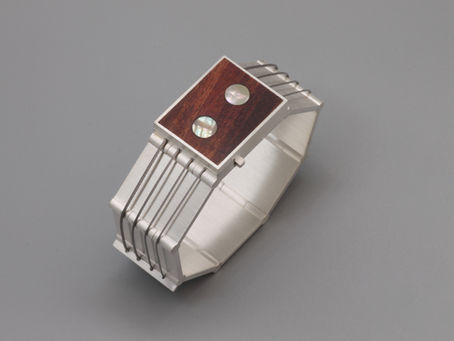 Armschmuck zum Thema „musikalisch inspiriert“ in Form eines abtraierten Gitarrenhals