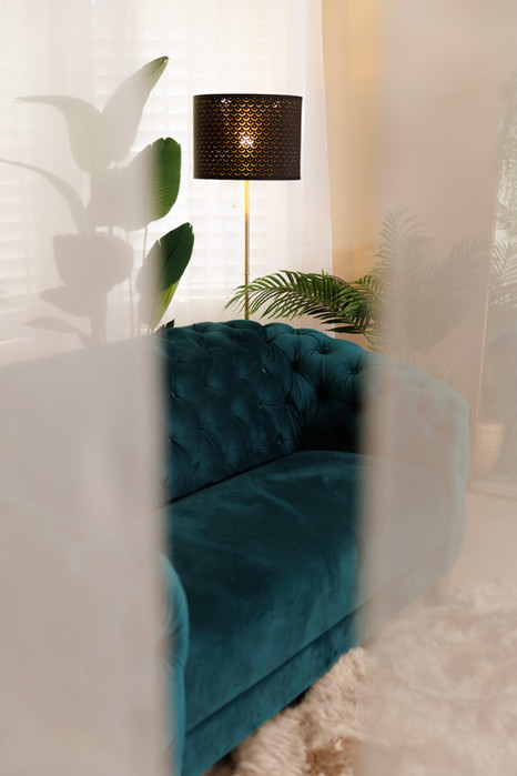 looking through sheer curtains into boutique studio