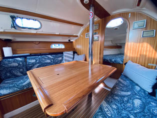 Dining Table - Features a foldable leaf on the starboard side for additional space when not in use.
