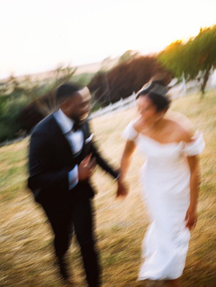 A blurry photo of a couple running during their wedding.