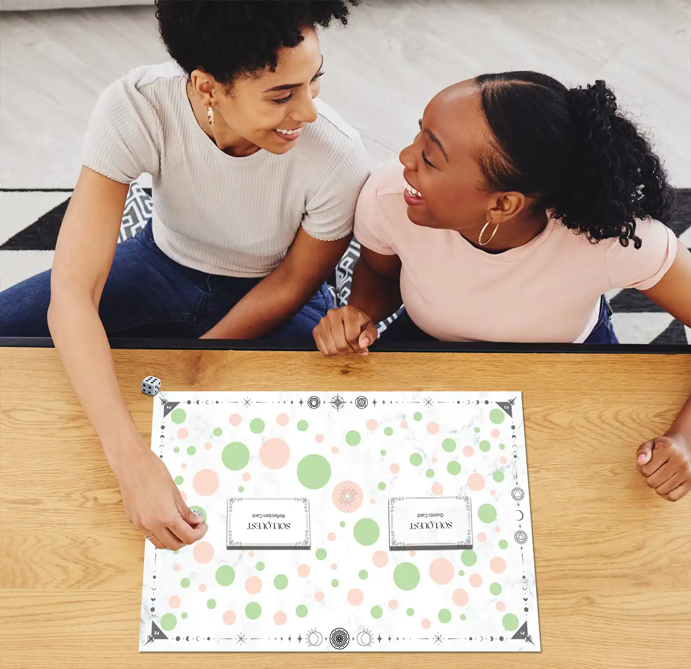 mother and daughter laughing plating a mindfulness board game
