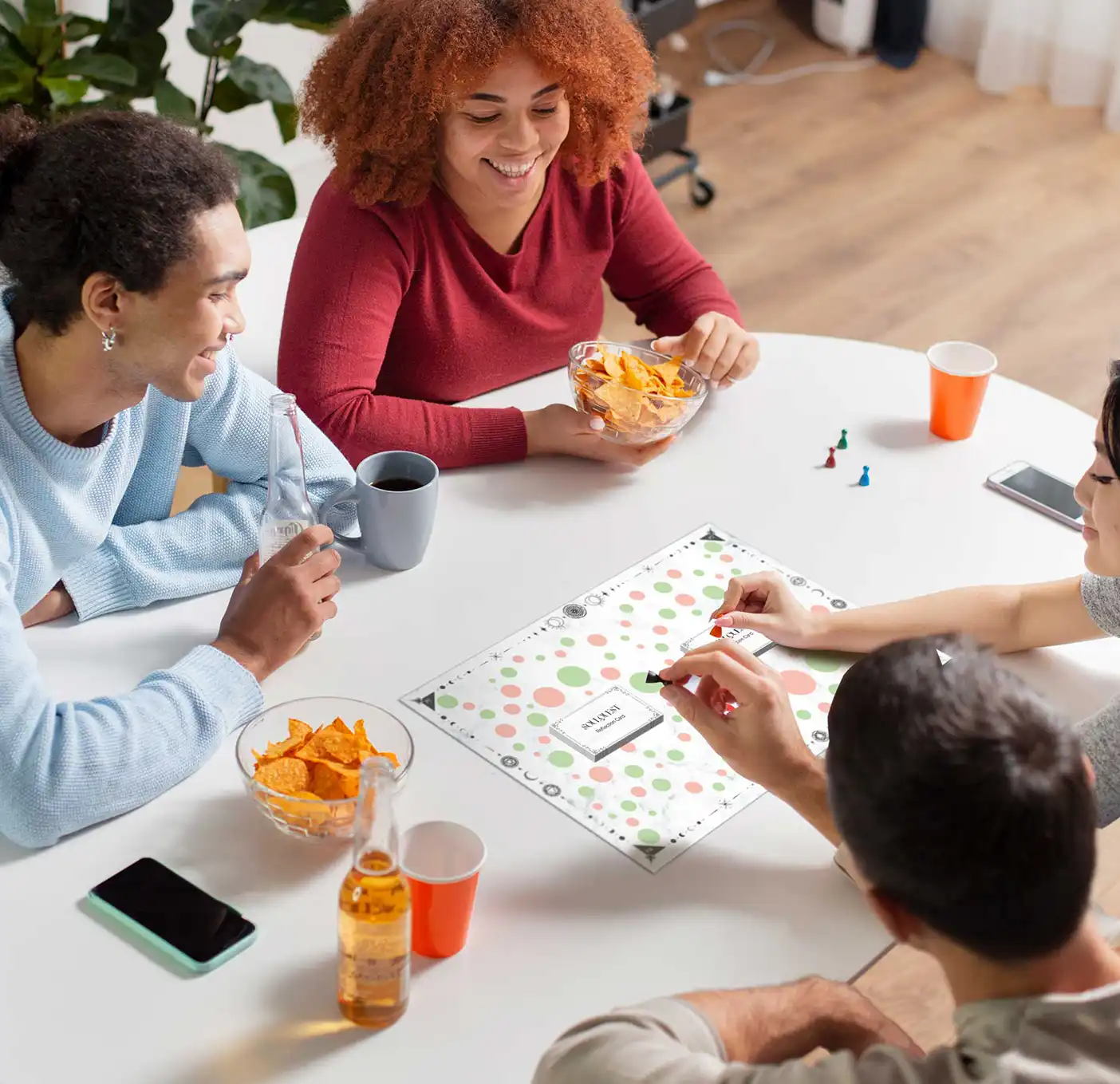 a group of friends smiling while playing a mindfulness board game