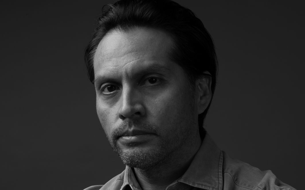 Close-up professional headshot of a man working in technology, wearing business casual attire.