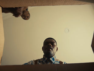 A man looking down into a moving box.