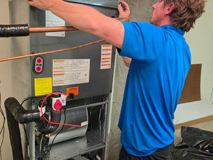 Simply Right technician Cory finishing an indoor HVAC air-handler installation near Jacksonville, NC.