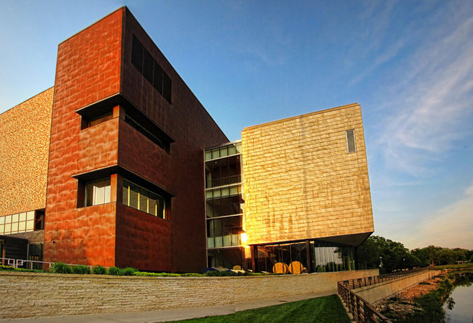Today's Rochester Art Center building: copper and gold-toned blocks beside the river at sunset