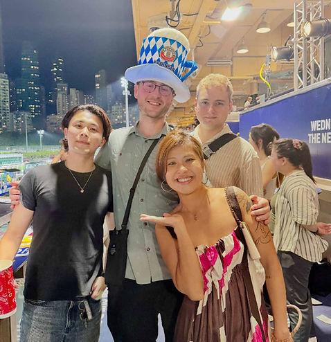 Guests attending Happy Wednesday at Happy Valley Racecourse overlooking live horse racing, one of the most popular social events in Hong Kong for making friends and enjoying midweek activities.