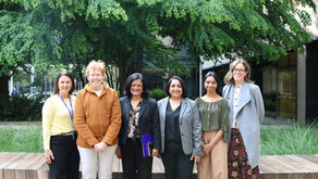A group photo of six people standing outside.
