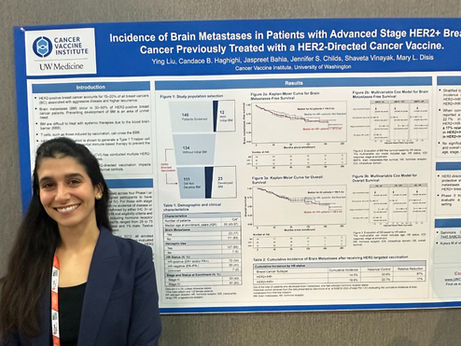 Dr. Candace B Haghighi standing in front of the poster presentation.