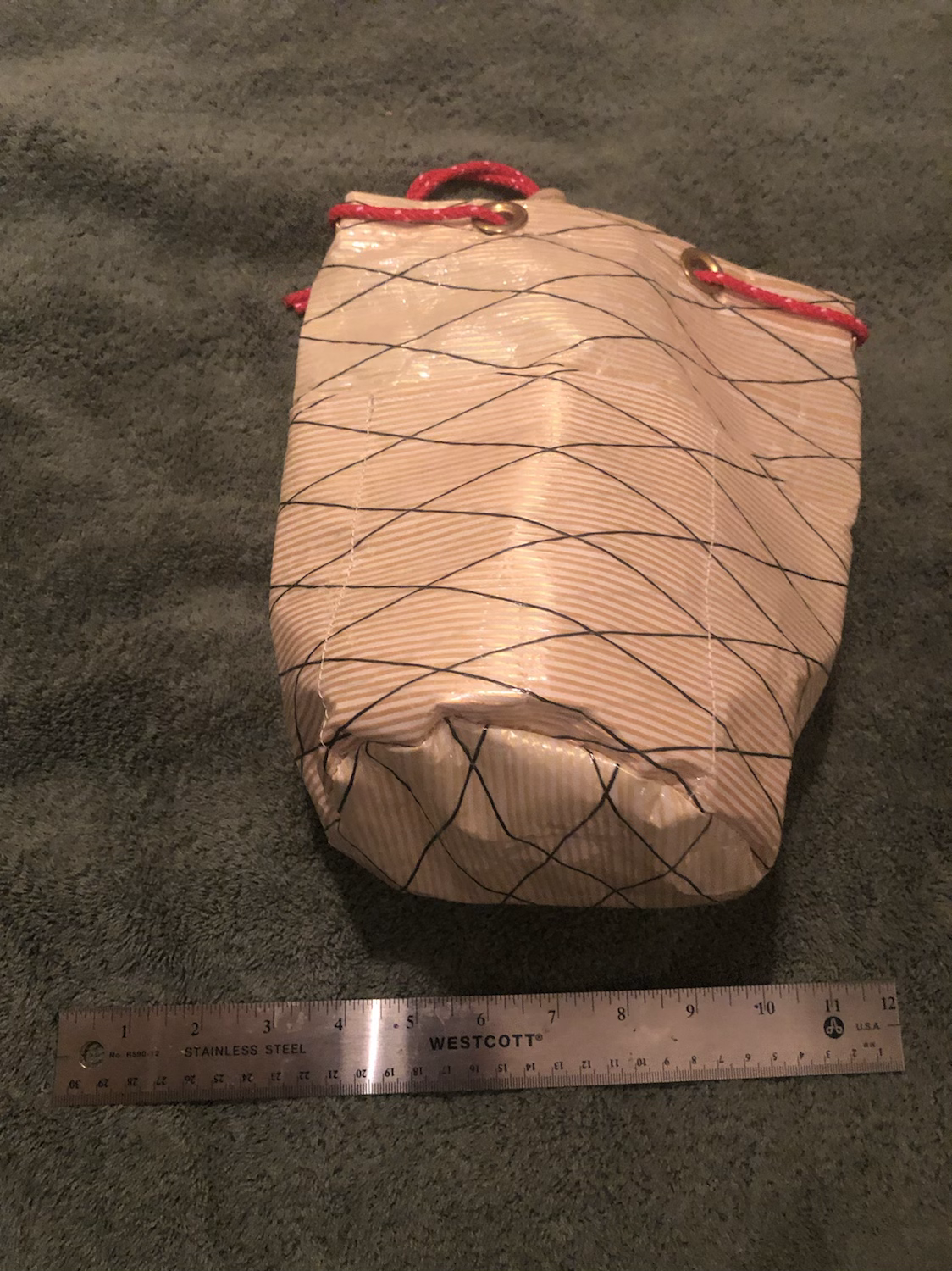 Stuff sack with exterior pockets with a red pull