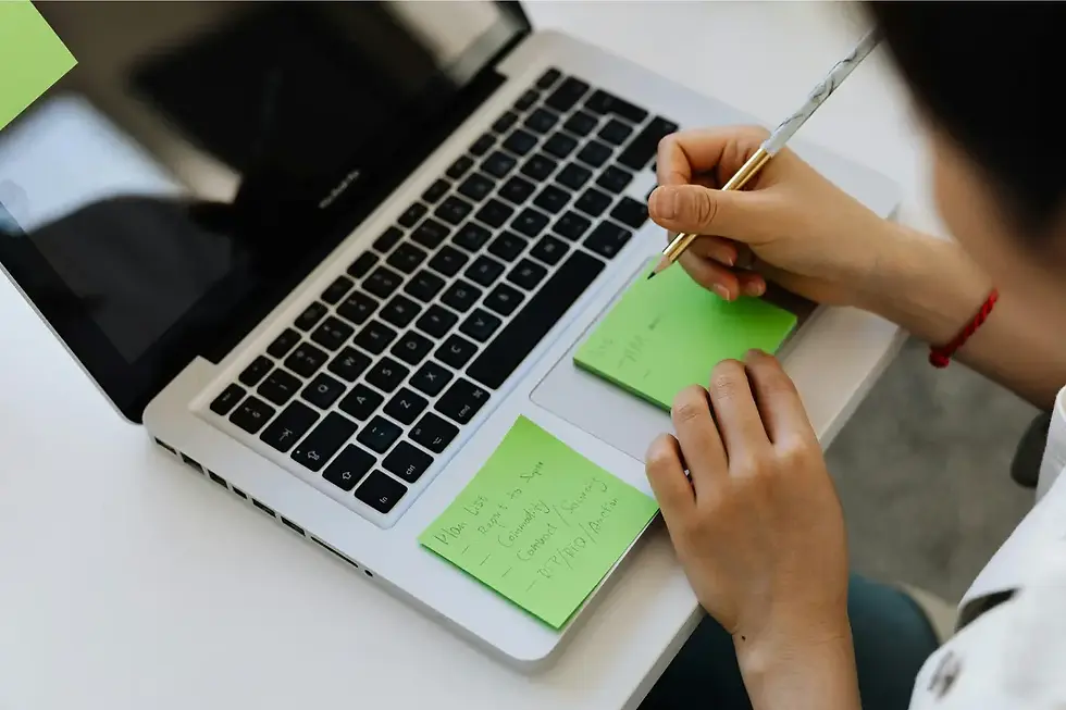 person taking notes on sticky notes so they can try to remember tasks