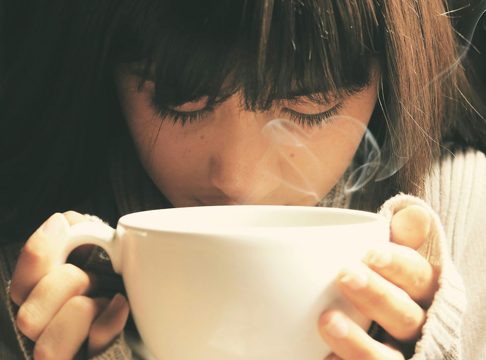 woman close up of face with tea, eyes closed and steam