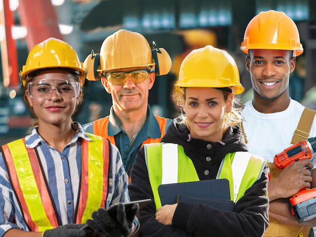 Four construction workers in PPE smiling into the camera with the words "Will it be you?" (as in, will you be the first contractor to be spotlighted in our first issue) highlighted in front of them.