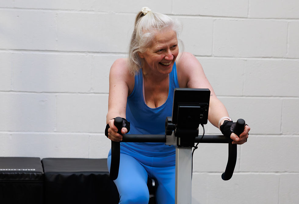 Female member cycling during a small group personal training session at Prime Fitness in Royal Wootton Bassett, building strength, fitness and confidence.