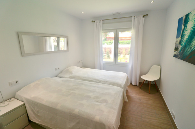 Two single beds in cozy modern room.