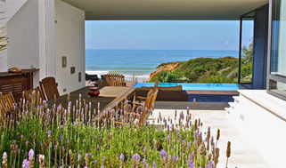 Terrace with wooden table overlooking the Atlantic Ocean and coastal dunes near Conil de la Frontera.