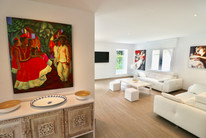 Bright living space with artwork and modern furniture.