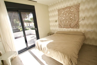 Double bedroom with doors to private terrace.