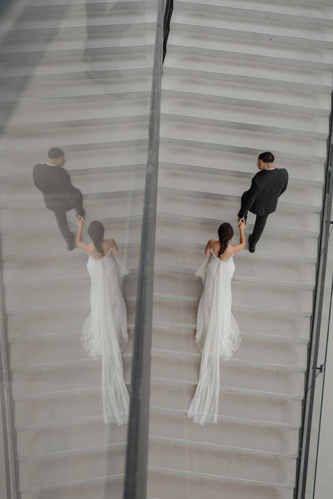 Brautpaar von oben fotografiert wie sie die Treppe hoch laufen