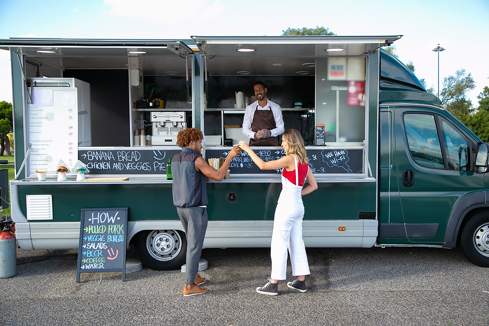 2 people infront of a food truck