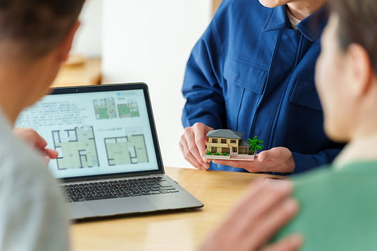young asian architect explaining house plan to senior asian couple.jpg