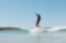 Cornwall UK surf yoga retreat guest surfing summer waves on a longboard