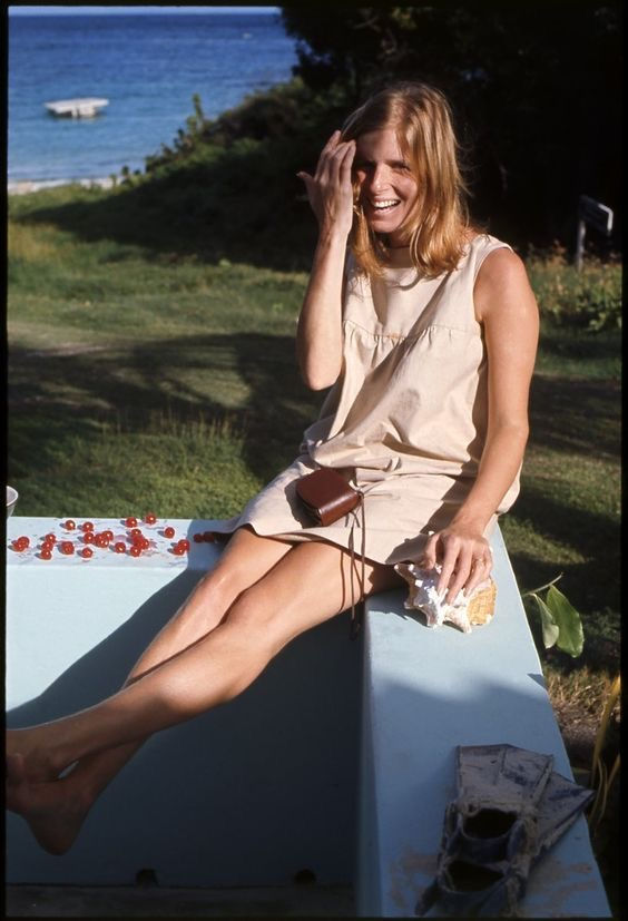 Blonde woman smiling on wall with cherries