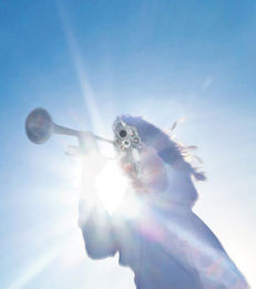 Angel against blue sky with horn and revolver