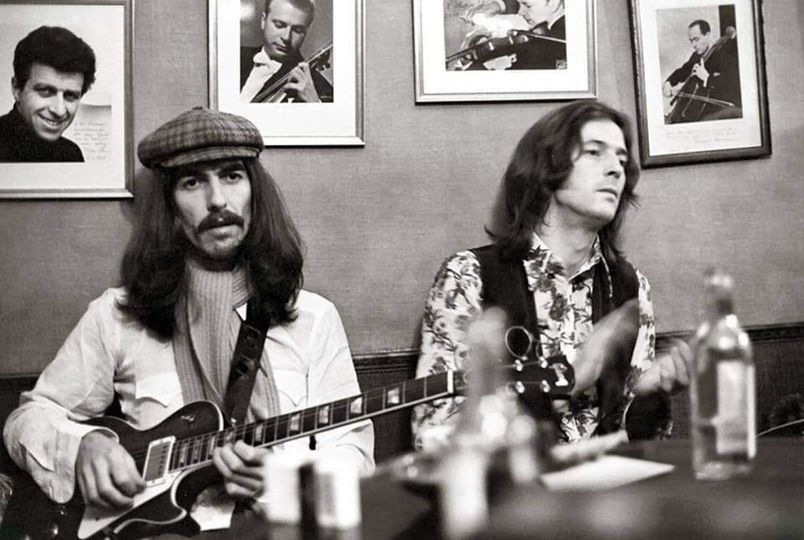 Black and white photo of long-haired men with guitars