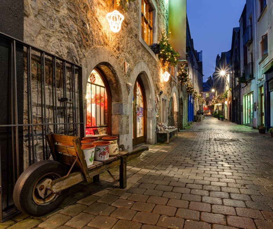 A view of cobblestoned Kerwan's Lane, Galway, Ireland at dusk.
