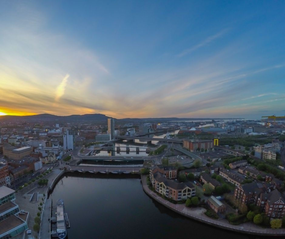 Aerial view of sunset over the river and city buildings in Belfast, Northern Ireland.