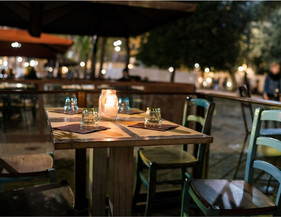 Outdoor table in Flornece set with candle and table settings.