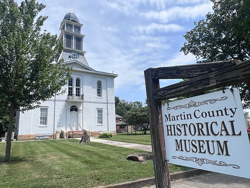 Martin County Historical Museum sign in front of white building on a sunny day