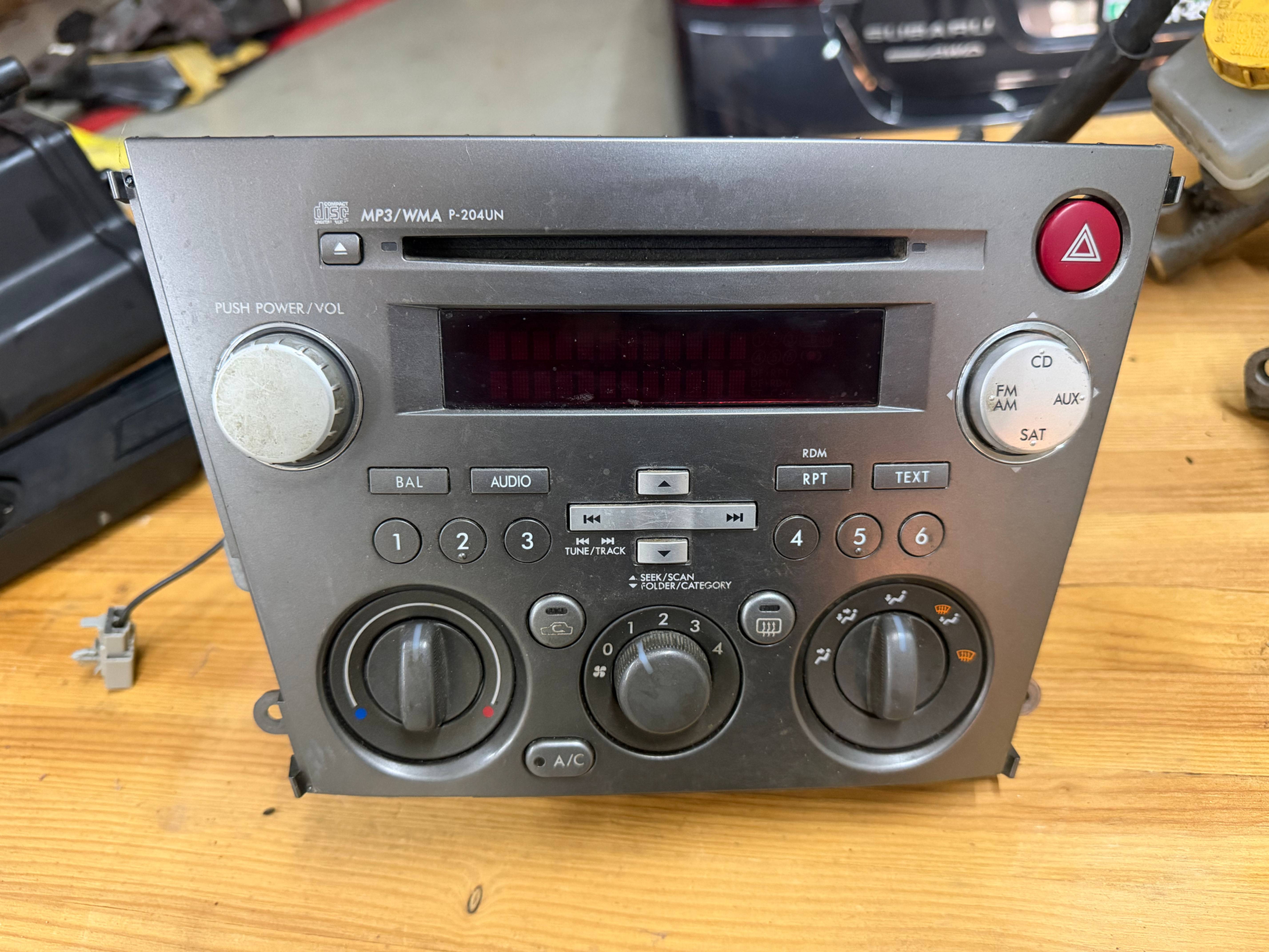Subaru Impreza OEM head unit with radio and HVAC controls