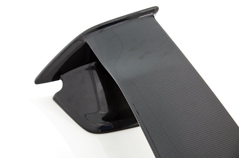 This OLM carbon fiber OEM STI style spoiler offers improved aerodynamics and