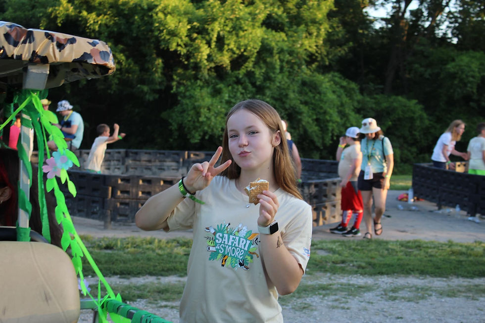 A young girl posing outside at Camp Quality Greater KC