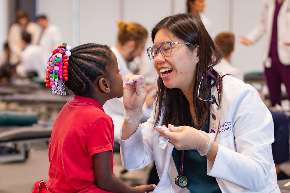 a female physician providing healthcare to a child at school through Score 1 for Health