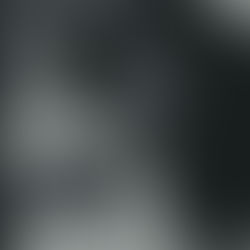 A woman smiling as a man embraces her.